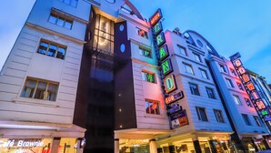 A hotel with a modern facade, multiple floors, and illuminated signage. - Hotel Grand Godwin near the New Delhi railway station & Connaught Place. (New Delhi)