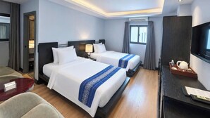 A hotel room with two beds, a desk, a television, and a window. - A&EM - The Petit Hotel (Ho Chi Minh City)