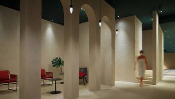 A modern interior with high ceilings, arched columns, and minimalist furniture.