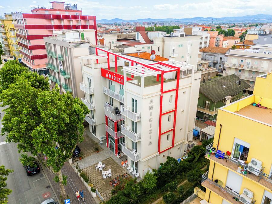 A multi-story building with balconies and a rooftop terrace.