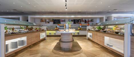 A modern kitchen with a central island, wooden cabinets, and a herringbone floor pattern.