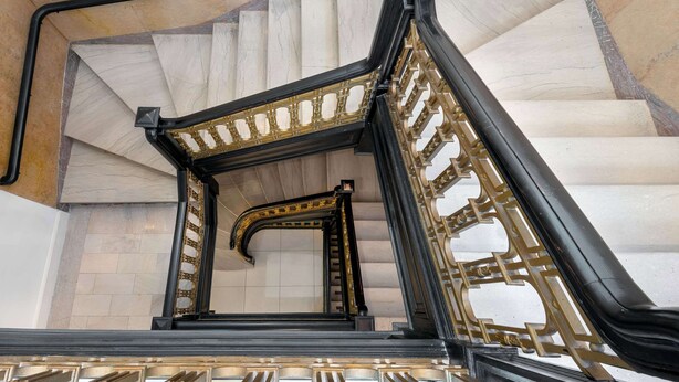 A grand staircase with ornate black and gold railings, marble steps, and a vaulted ceiling. - The Connally Hotel Downtown Atlanta, an Ascend Collection Hotel (Atlanta)