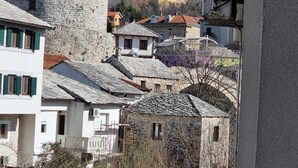 A traditional stone building with a sloped roof and a small arched window. - Villa Cardak (Mostar)