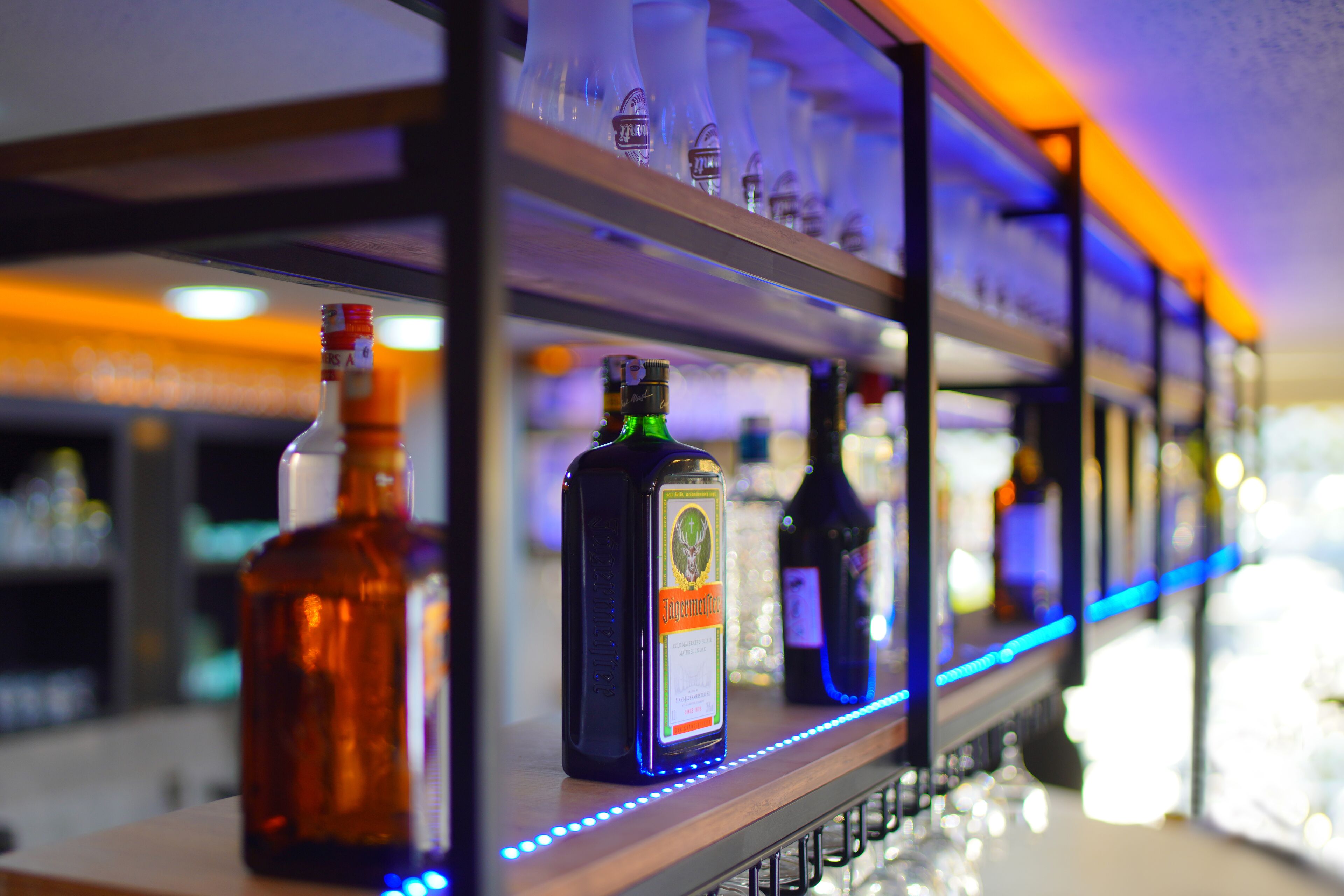 A bar with shelves of liquor bottles.
