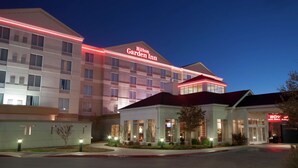 A multi-story hotel with a prominent sign reading "Hilton Garden Inn."