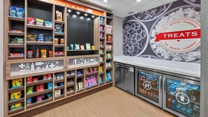 A snack display area with various packaged snacks and a refrigerated section. - Hampton Inn & Suites St. Louis/South I-55 (St. Louis)