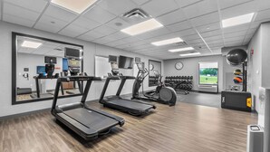 A gym with treadmills, exercise bikes, and a mirror. - Hampton Inn & Suites St. Louis/South I-55 (St. Louis)