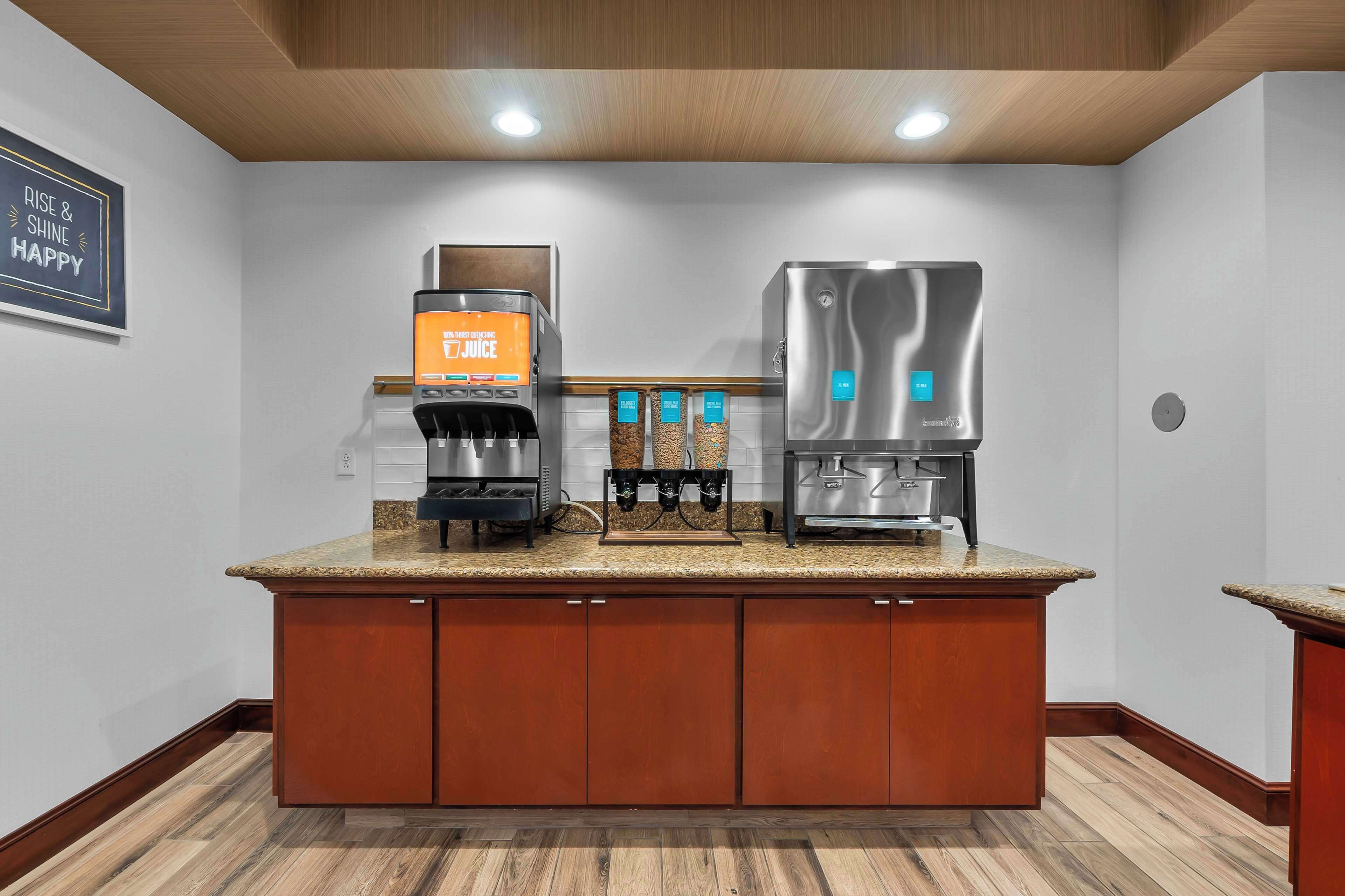 A modern kitchen with a coffee machine, a water dispenser, and a built-in oven.