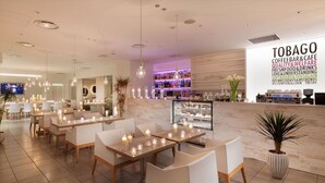 A modern restaurant interior with tables, chairs, and a bar area. - Hotel Plumm (Yokohama)