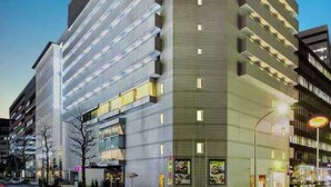 A modern hotel with multiple floors, large windows, and a prominent entrance. - Hotel Plumm (Yokohama)