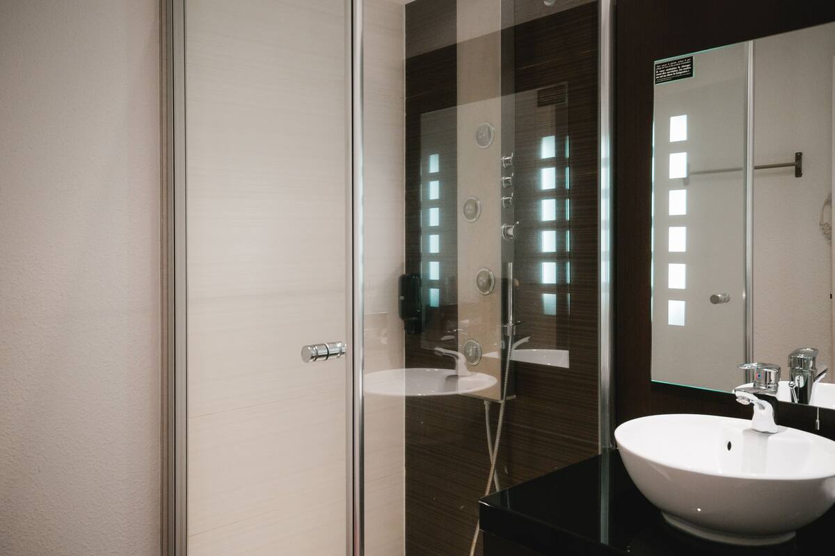 shower, rainfall showerhead, hair dryer, towels