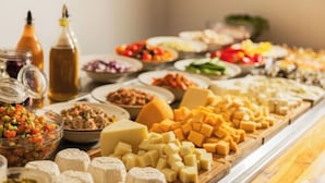 A buffet with various cheeses, fruits, and condiments. - Adam Boutique Eilat (Eilat)