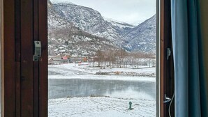 A view of a mountainous landscape with a lake and buildings in the background. - Lærdal Hotel (Laerdal)