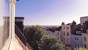 A view from a window overlooking a cityscape with buildings and a clear sky. - The Cavalaire (Brighton)