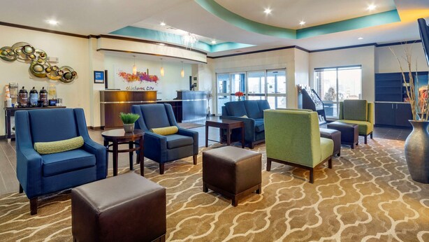 A lobby with seating areas, a reception desk, and a large window providing a view of the city. - Comfort Inn & Suites Oklahoma City West - I-40 (Oklahoma City)