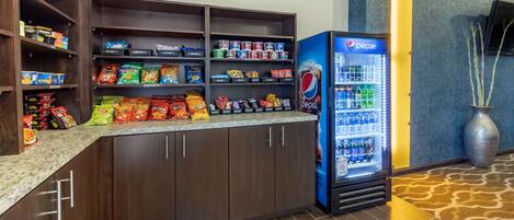 A snack bar with various packaged foods and a Pepsi refrigerator.