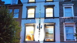 A hotel with a prominent sign reading "SIMPLY ROSE HOUSE HOTEL" and a visible entrance with a staircase leading to the door. - Simply Rooms & Suites (London)