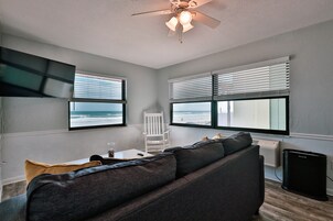 Signature Suite | Living area | 50-inch flat-screen TV with cable channels, TV