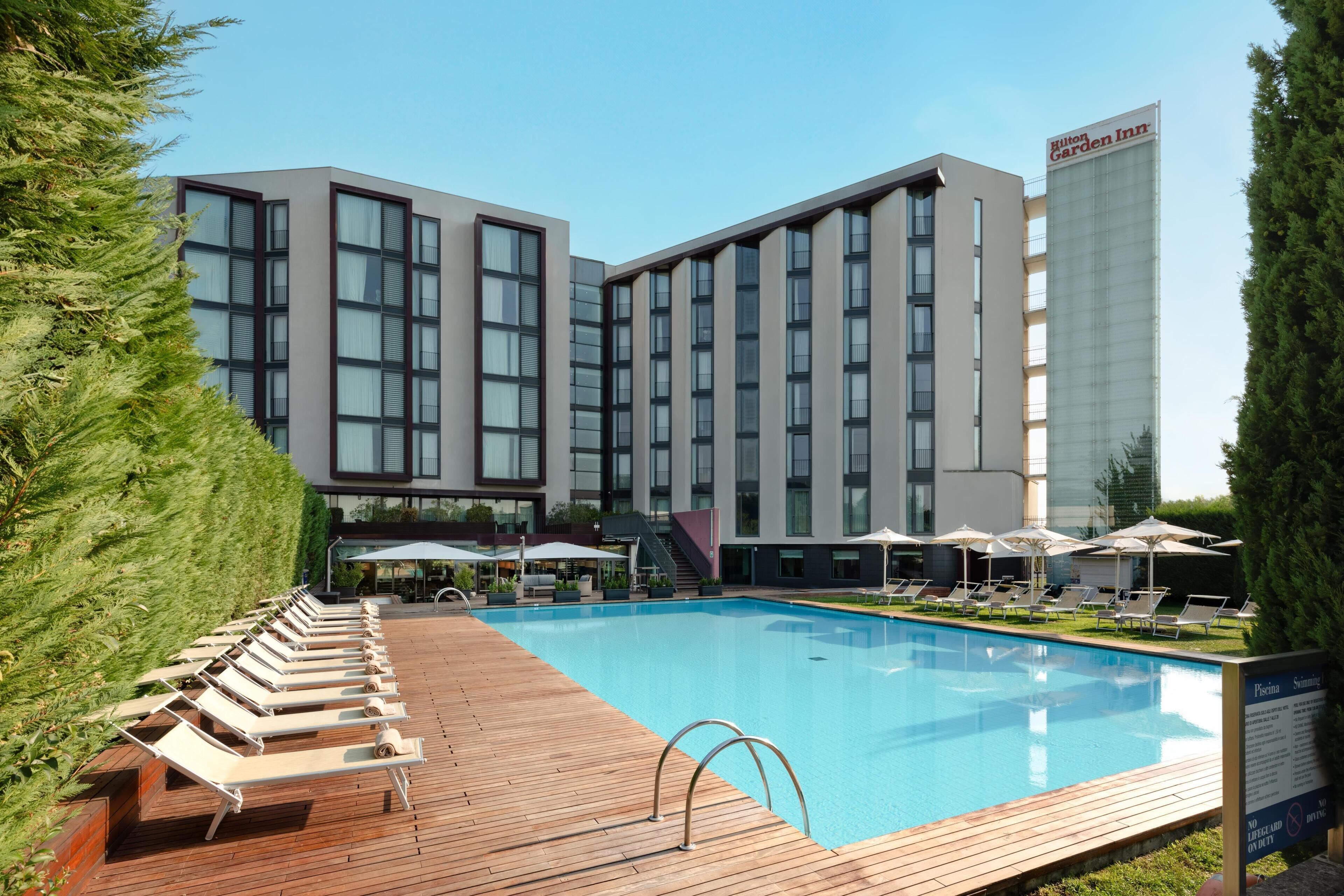 Seasonal outdoor pool, open 8:00 AM to 7:00 PM, pool umbrellas