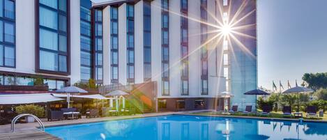 Seasonal outdoor pool, open 8:00 AM to 7:00 PM, pool umbrellas