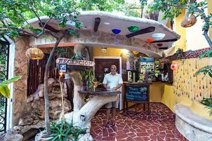 A reception area with a stone archway, a reception desk, and a sign that reads "RECEPTION".
