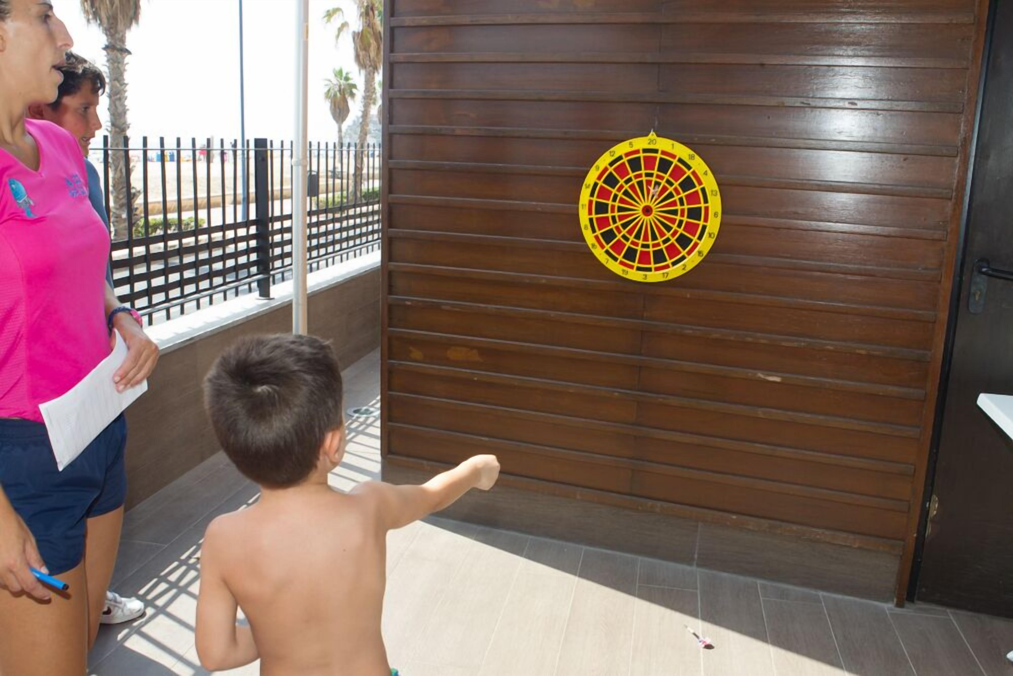 A dartboard mounted on a wooden wall.