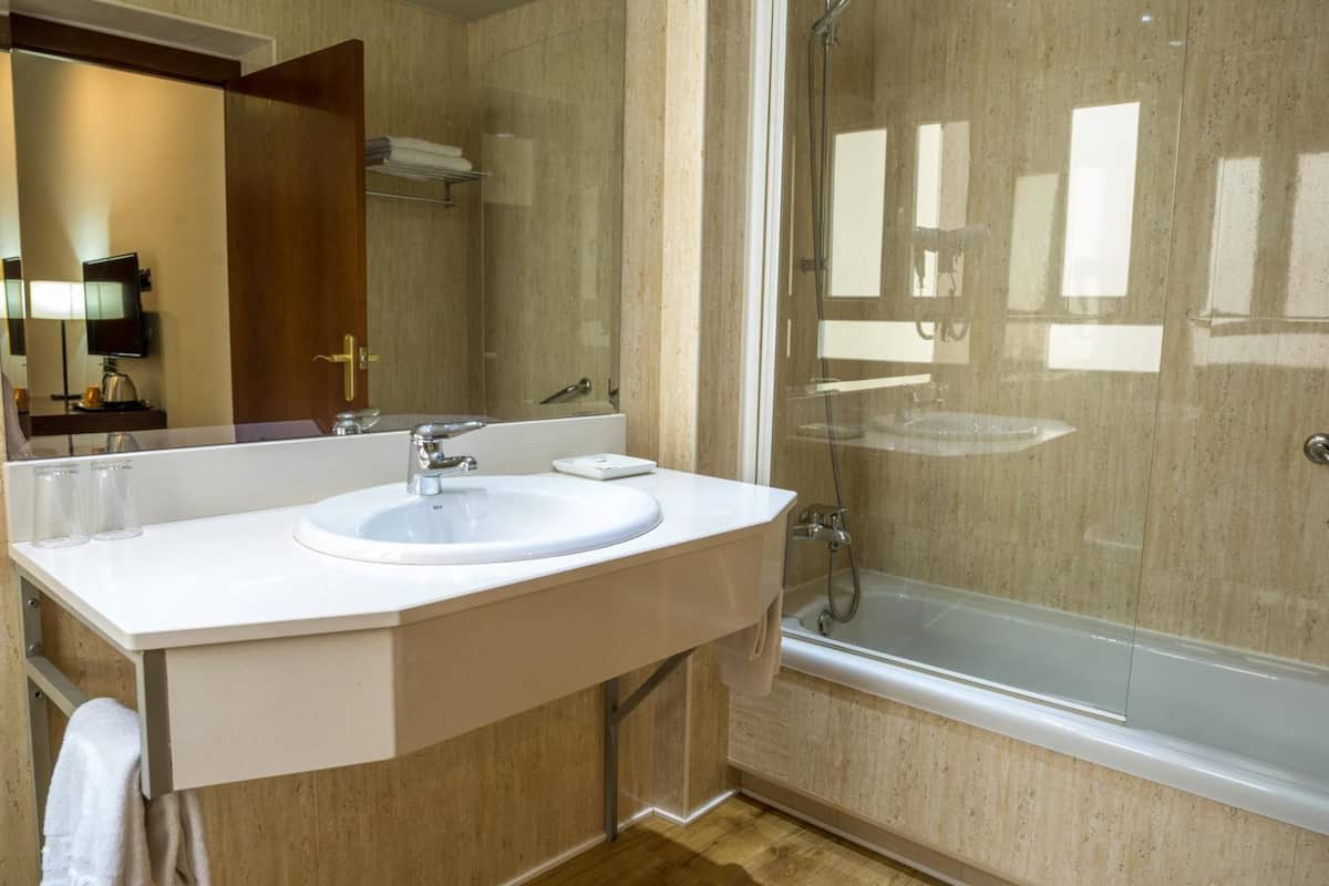 bathtub, hair dryer, towels