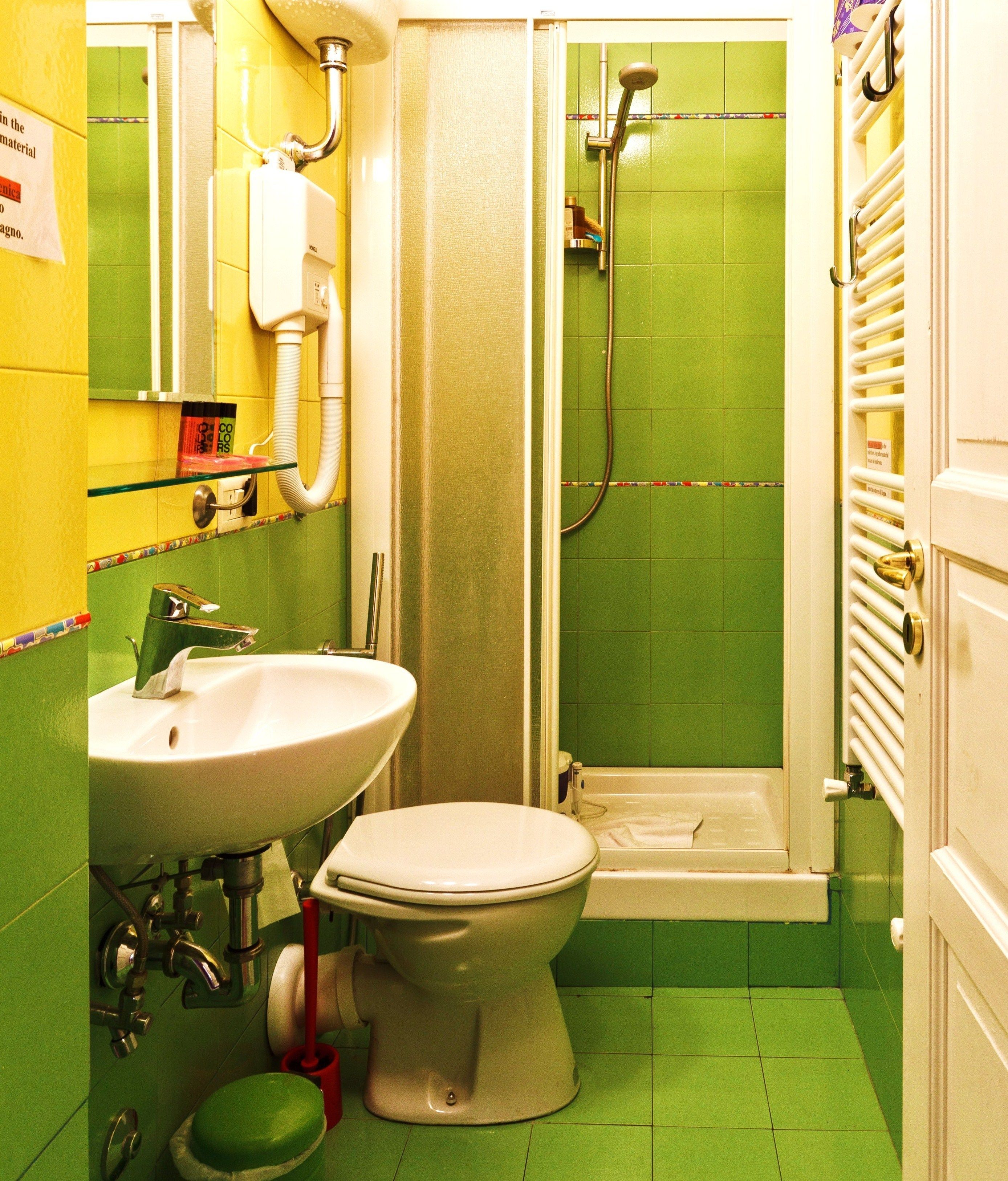 A bathroom with a toilet, sink, and shower.
