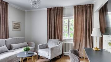 Familie suite | Woonruimte | Een 50-inch flatscreentelevisie met satellietzenders en Netflix