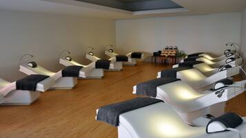 Relax in comfort with reclining chairs, headrests, and footrests, amidst a serene atmosphere and spa amenities.