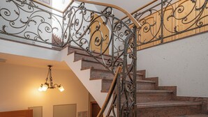 A staircase with ornate metal railings and wooden steps. - Rooms & Apartments Pr Matjon (Bled)