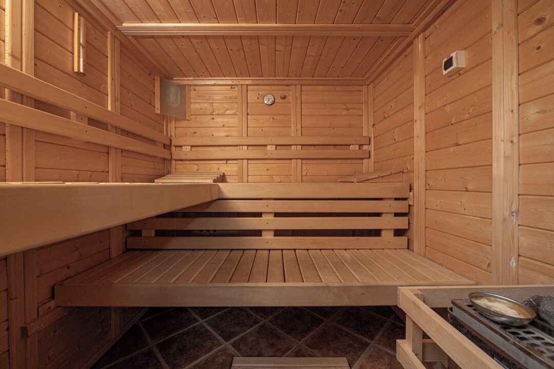 A wooden sauna with benches and a bench seat.