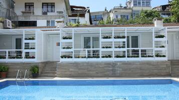 Seasonal outdoor pool, pool umbrellas, pool loungers