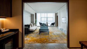 A modern living room with a sofa, a coffee table, and a rug.