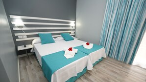 A modern hotel room with a large bed, a bedside table, and a nightstand. - RF Apartamentos Bambi - Adults Only (Puerto de la Cruz)