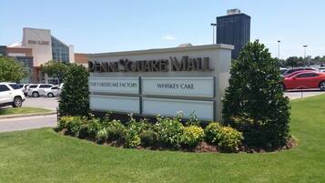 A sign for Penn Square Mall with The Cheesecake Factory and Whiskey Cake listed as food options.