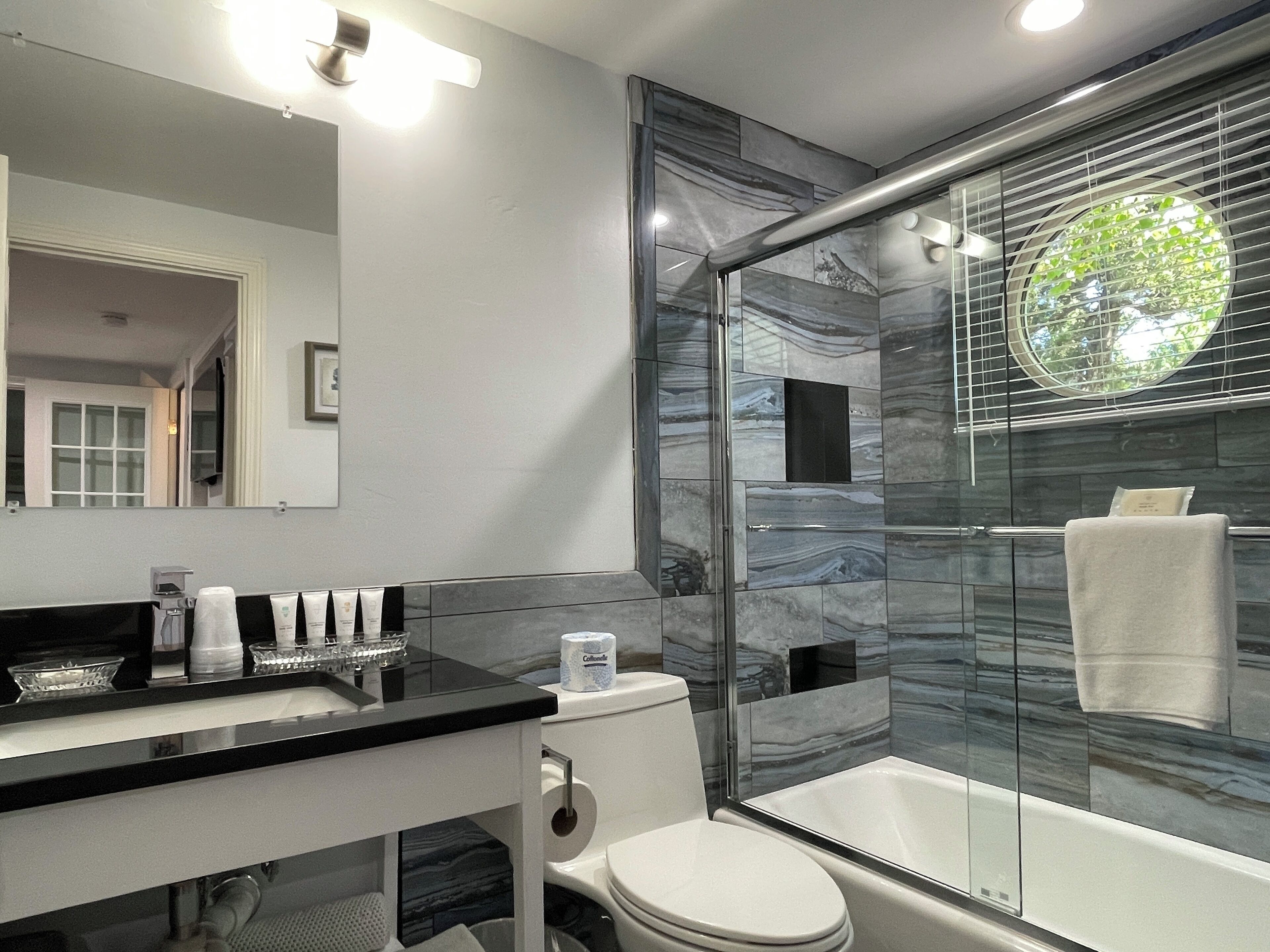 upper deluxe two bedroom cottage | bathroom | combined shower/bathtub, free toiletries, hair dryer, towels