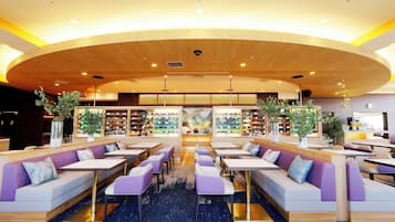 A modern interior with seating areas, a central display, and a variety of bookshelves.