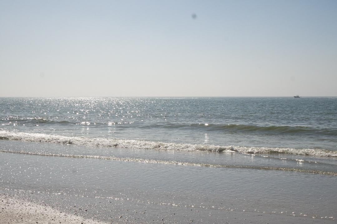On the beach, white sand, beach cabanas, beach towels