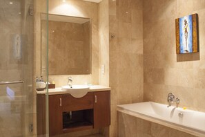 Separate bathtub and shower, hair dryer, bathrobes, towels - The Segara Suites (Nusa Dua)