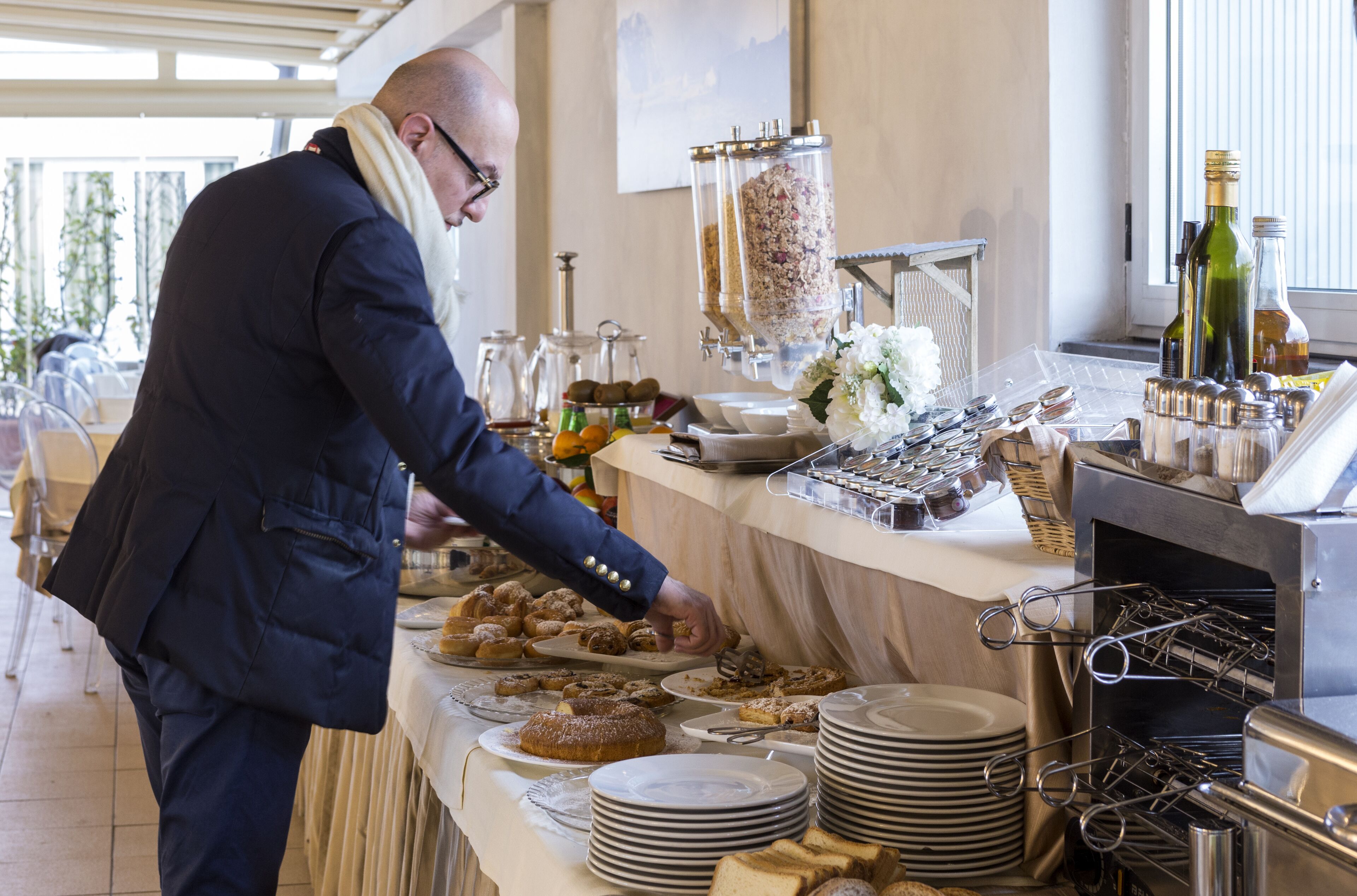 A buffet setup with various food items and a beverage station.