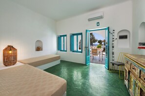 Traditional Quadruple Room, Sea View | Living area | 32-inch flat-screen TV with satellite channels, TV, books