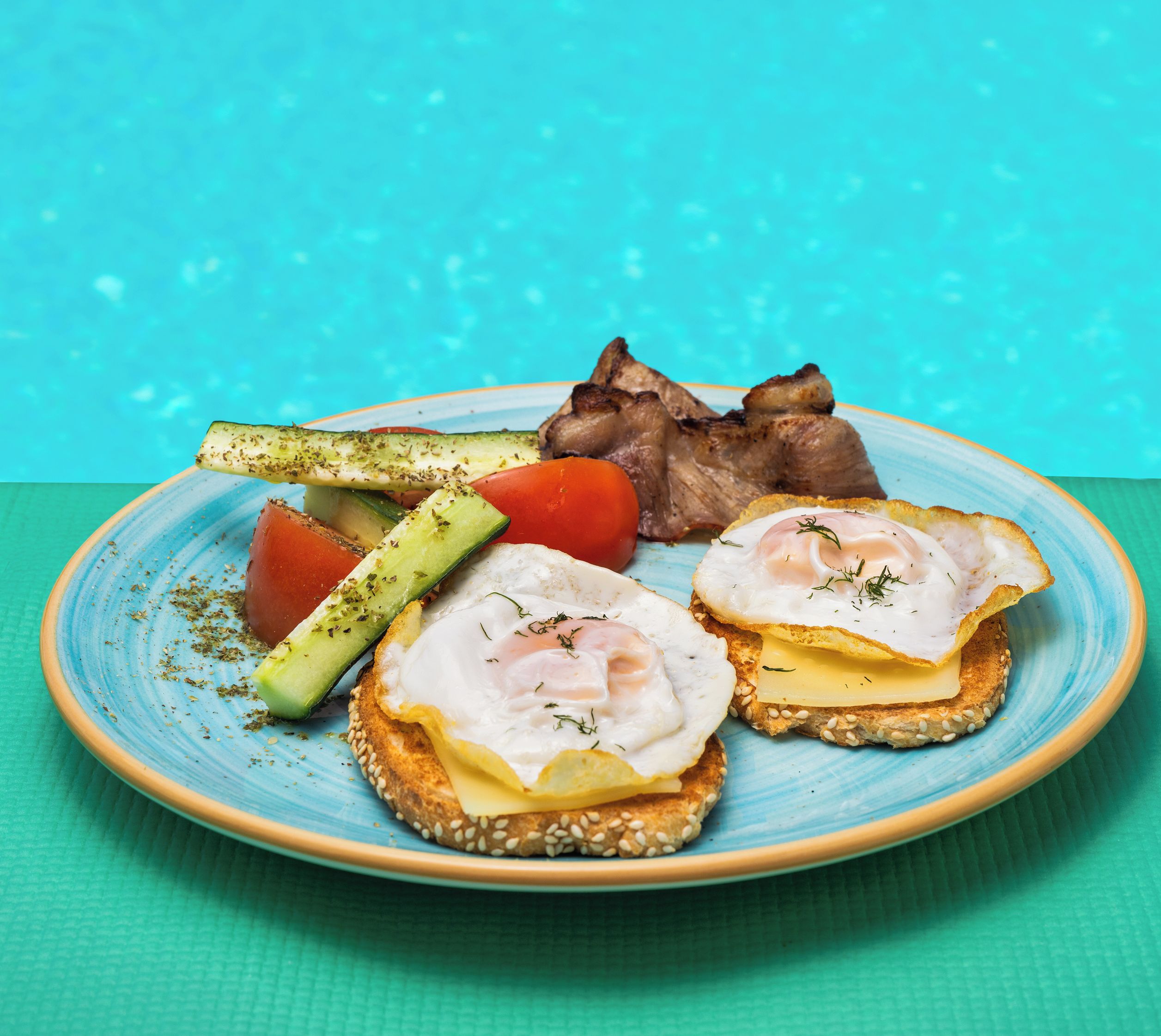 A plate of food with eggs, cheese, and vegetables on a blue plate.