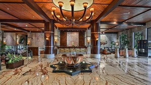A spacious lobby with a marble floor, a central chandelier, and large wooden beams on the ceiling. - Fariyas Resort Lonavala (Mawal)