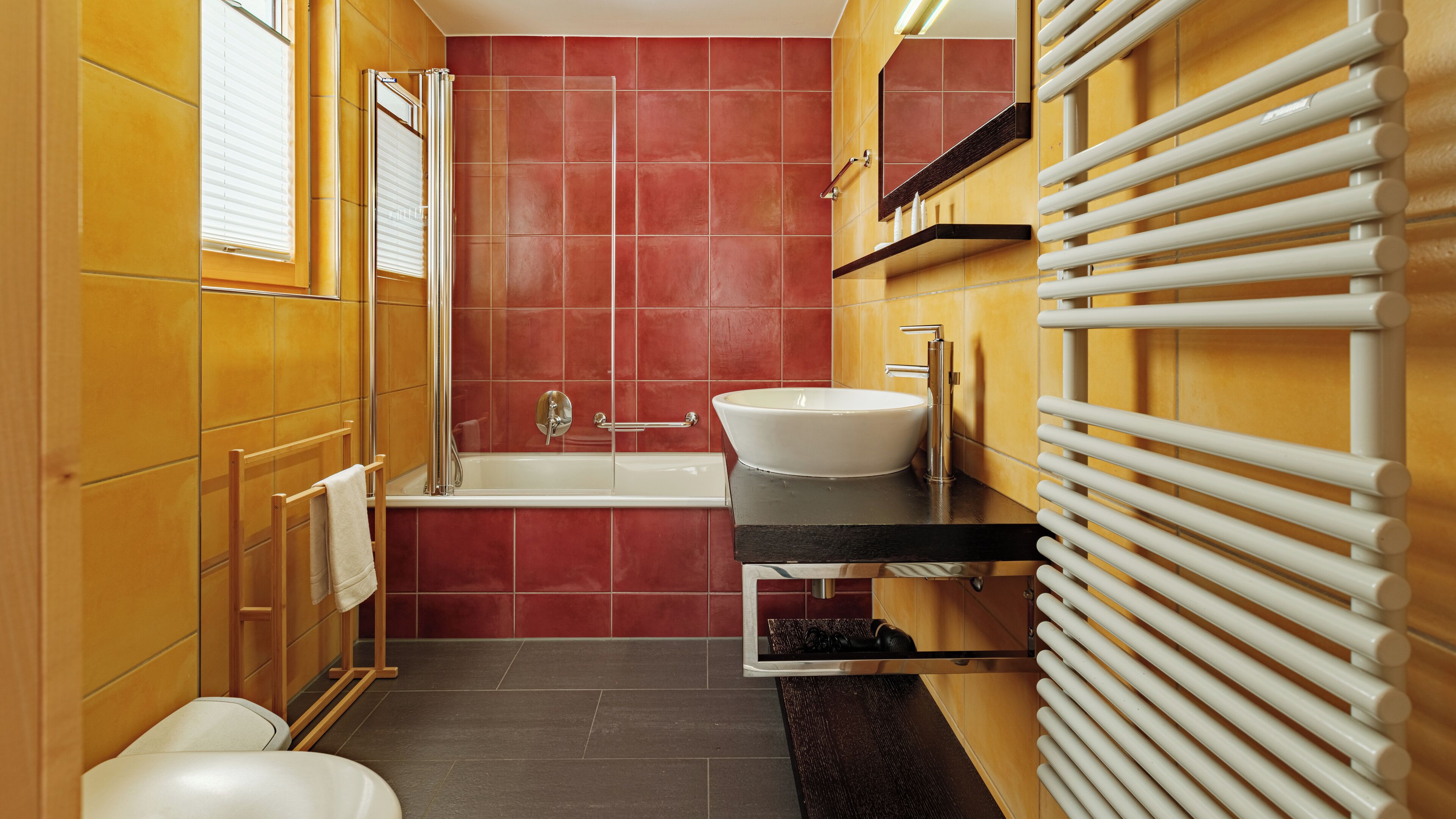 A modern bathroom with a bathtub, a sink, and a shower.