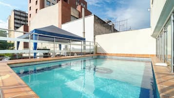 Outdoor pool, open 9:00 AM to 9:00 PM, pool umbrellas, pool loungers