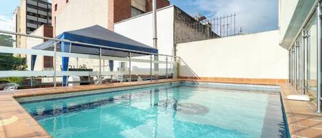 Outdoor pool, open 9:00 AM to 9:00 PM, pool umbrellas, sun loungers