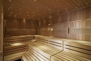 Una sauna con bancos de madera y paredes de listones.