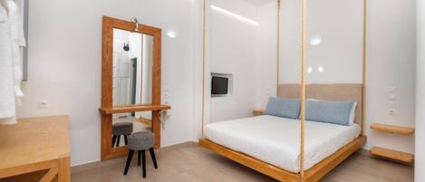 A modern bedroom with a hanging bed, a wooden desk, and a small stool.