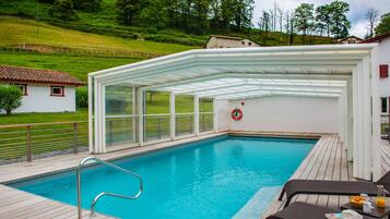 Seasonal outdoor pool, open 10:00 AM to 7:00 PM, pool umbrellas